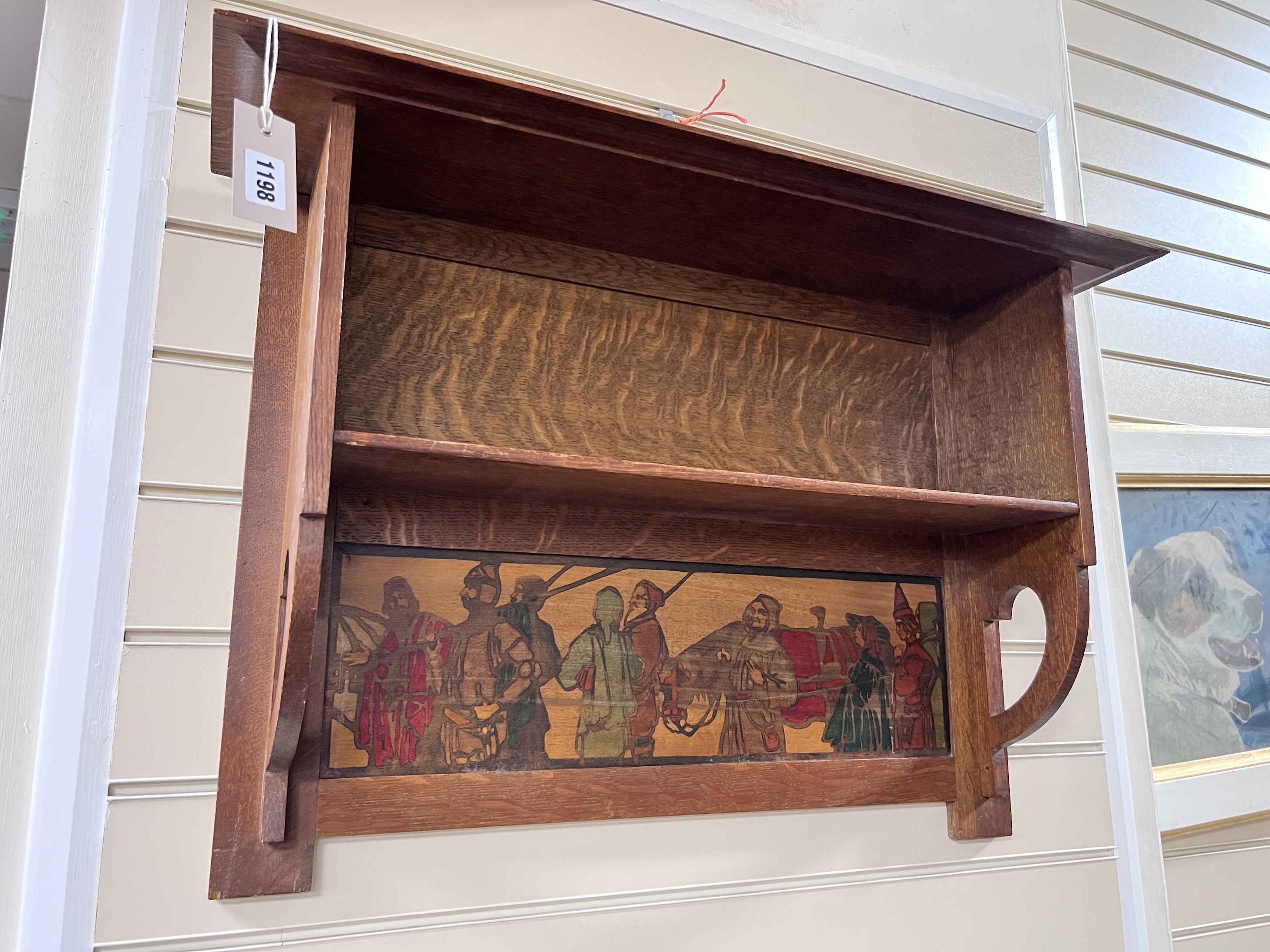 An Arts & Crafts oak shelf unit with stencilled decoration after Brangwyn, width 78cm, height 52cm